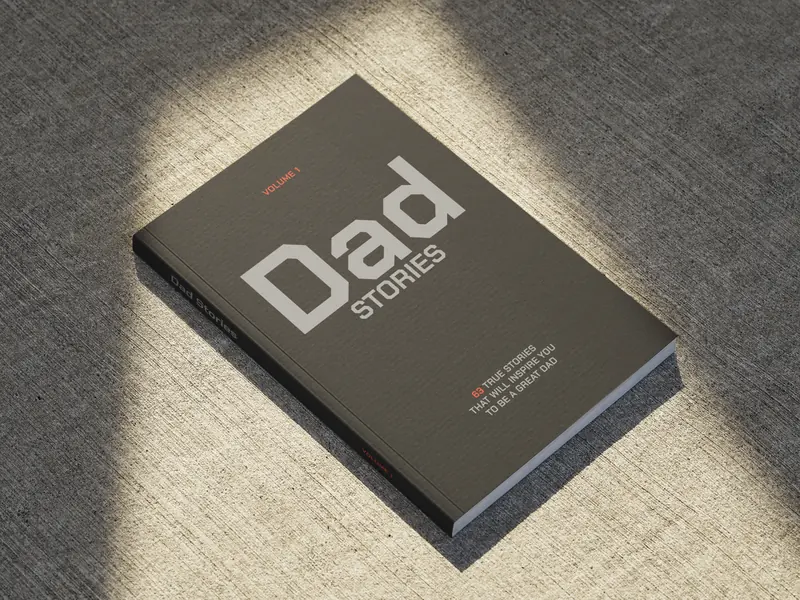 Dad Stories from the That's My Dad Project, a charcoal paperback in a beam of light