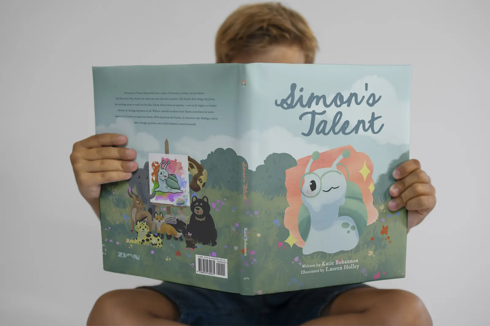 A child reading Simon's Talent, the back cover facing the camera