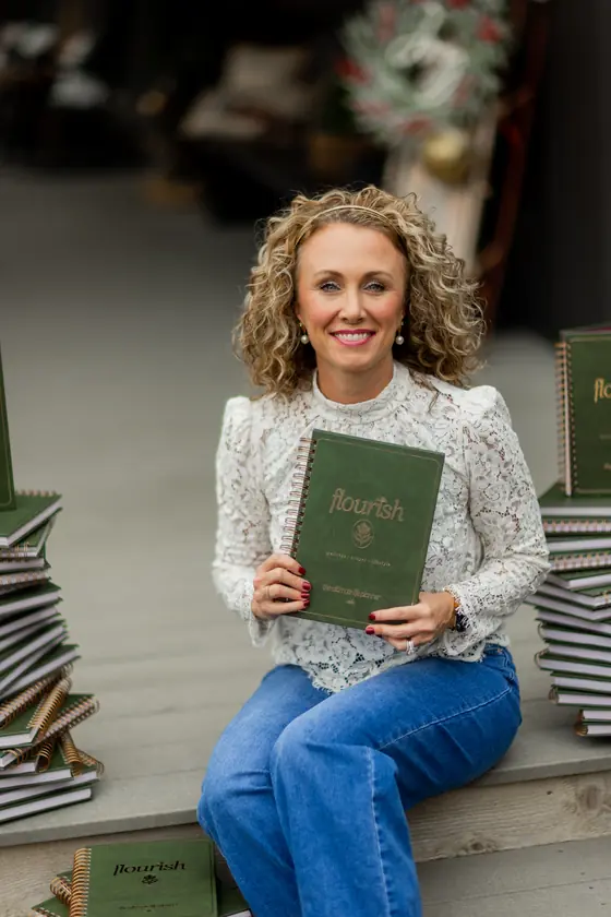 Michelle Johnson seated with a stack of planners
