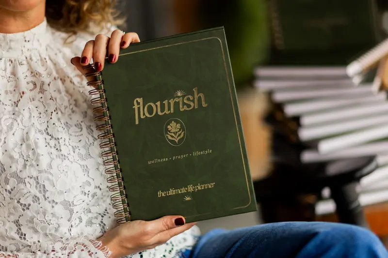 Close-up of hands holding the Flourish cover