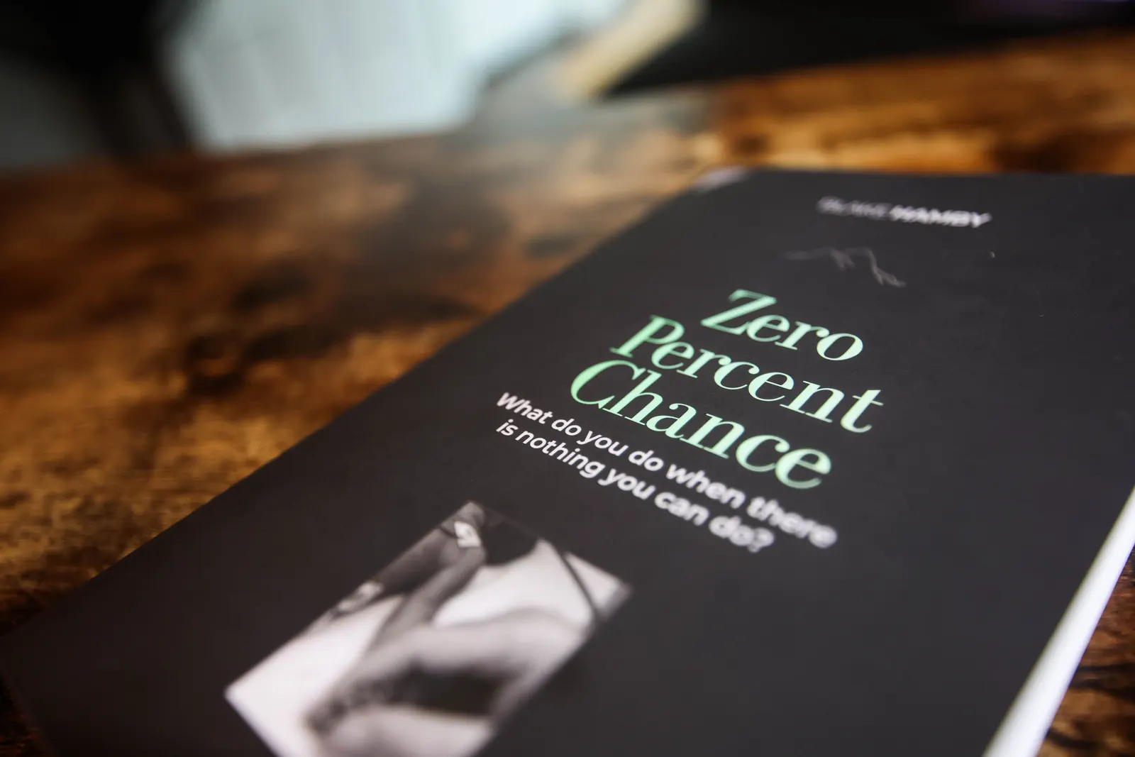 Close-up of the Zero Percent Chance cover on a wooden table